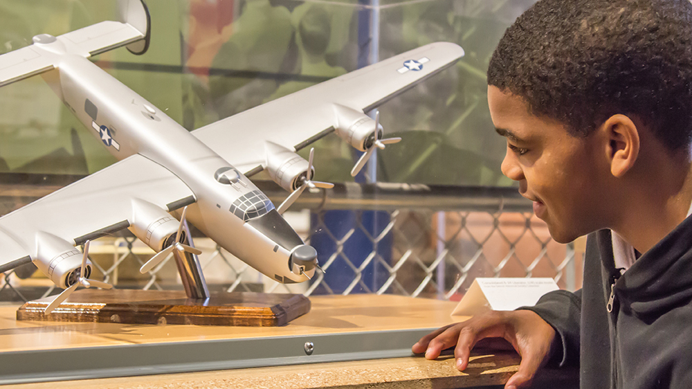Young boy looking at an airplane museum exhibit