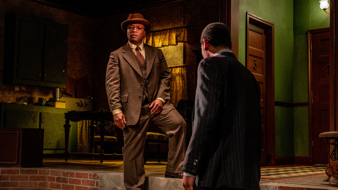 Two actors on stage for a performance at Detroit Public Theatre