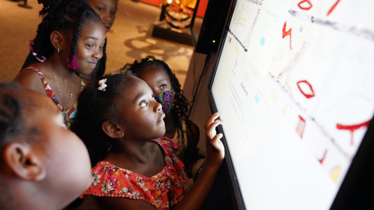 children looking at a museum exhibit