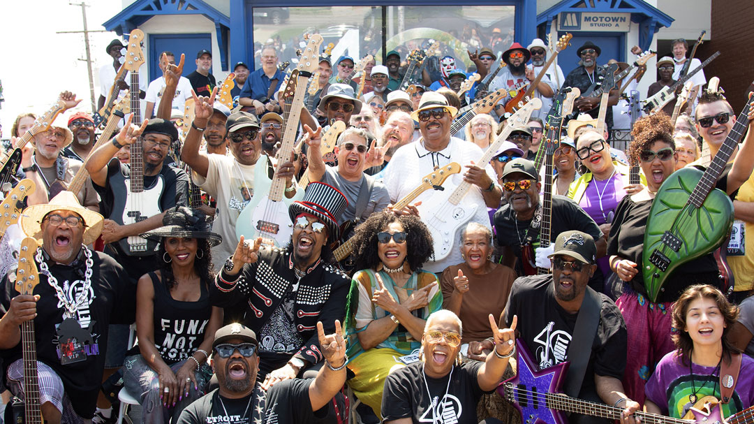 a large group of people in front of The Motown Museum
